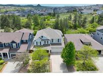 Charming two-story home boasts a well-manicured front yard and a two-car garage in a desirable neighborhood at 1271 Sky Rock Way, Castle Rock, CO 80109