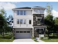 Beautiful two-story home featuring a two-car garage, white siding and decorative stone accents at 6747 E 149Th Ave, Thornton, CO 80602