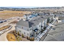 Gorgeous aerial view of new construction townhomes, landscaping, and mountain views in the background at 8055 Navajo River Loop # B, Littleton, CO 80125