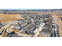 Community aerial view shows modern homes in a well-planned neighborhood with mountain views at 8055 Navajo River Loop # B, Littleton, CO 80125