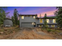 Charming two-story home featuring a two-car garage and a well-maintained front yard at 10142 S Turkey Creek Rd, Morrison, CO 80465