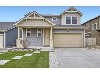 Two-story home with a gray exterior, well-kept lawn, two car garage, and stylish curb appeal at 18263 E 52Nd Ave, Denver, CO 80249