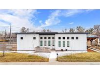 Striking modern home featuring a flat roof, light exterior, and contemporary design at 2650 W Asbury Ave, Denver, CO 80219