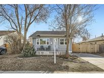 Charming single-story home with a cozy front porch and well-maintained yard at 1548 Ulster St, Denver, CO 80220