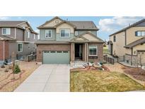 Beautiful two-story home featuring a brick facade, attached garage, and well-maintained landscaping at 7565 S Quantock Ct, Aurora, CO 80016