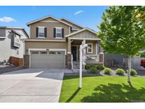 Inviting two-story home with a well-maintained lawn and a welcoming front porch at 13144 E 109Th Pl, Commerce City, CO 80022