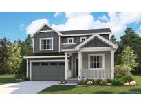Charming two-story home with gray siding, white trim, covered porch, and an attached two-car garage at 8045 Butte Creek St, Littleton, CO 80125