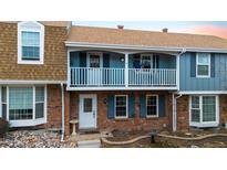 Charming townhouse featuring brick facade, balcony, and well-maintained front landscaping at 2783 E Geddes Pl, Centennial, CO 80122