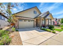 Charming two-story home featuring a two-car garage, covered porch, and landscaped front yard at 6670 Club Villa Rd, Parker, CO 80134