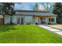 Charming home featuring a well-manicured lawn and inviting entrance with modern walkway and covered porch at 4790 E Dartmouth Ave, Denver, CO 80222