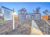 Newly painted blue house with walkway and yard at 1373 S Wolff St, Denver, CO 80219