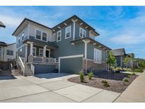 Beautiful two-story home featuring a two-car garage and welcoming front porch at 74 Lullaby Ln, Castle Rock, CO 80109
