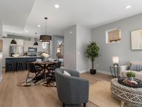 Bright open-concept living space featuring hardwood floors, modern furnishings, and access to a stylish kitchen at 1248 Josephine St # 2, Denver, CO 80206