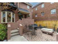 Inviting outdoor patio area with brick pavers, perfect for entertaining or relaxing with a table, chairs, and seating at 999 N Emerson St # 9, Denver, CO 80218