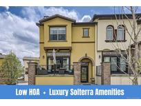 Charming two-story home with a well-maintained front yard and a welcoming entrance with brick design at 15576 W Washburn Cir, Lakewood, CO 80228