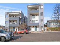 Modern, multi-story townhomes with sleek gray and white exteriors, complemented by well-maintained landscaping at 1245 Utica St # 105, Denver, CO 80204