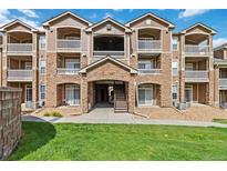 Beautiful condo exterior featuring stone accents, balconies, and well-maintained landscaping at 7440 S Blackhawk St # 14-103, Englewood, CO 80112