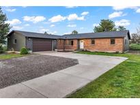 Charming single-story brick home with attached garage, long drive and welcoming curb appeal at 8092 Ponderosa Ln, Parker, CO 80138