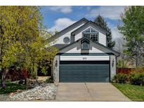 Charming two-story home featuring a well-manicured lawn and a two-car garage at 879 E 133Rd Ave, Thornton, CO 80241
