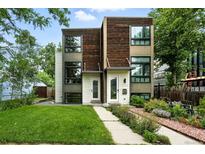 Modern exterior showcasing a well-maintained lawn, walkway, and landscaped garden beds enhancing curb appeal at 4129 Zenobia St, Denver, CO 80212