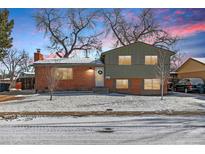 Charming two-story home with brick and siding exterior, winter landscape, and cozy curb appeal at 950 Laurel St, Broomfield, CO 80020