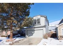 Charming gray two-story home featuring an attached two-car garage and a well-maintained front yard at 8034 Decatur St, Westminster, CO 80031