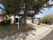 Charming two-story home with attached garage and mature tree in the front yard at 8034 Decatur St, Westminster, CO 80031