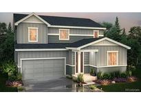 Charming two-story home featuring a gray facade, a two-car garage, and well-maintained landscaping at 267 Marlowe Dr, Erie, CO 80516