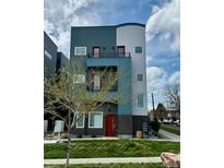 Modern three-story home with gray and blue facade, red door, and small front yard at 1299 Osceola St, Denver, CO 80204