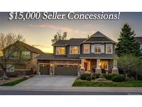 Inviting two-story home featuring a stone facade, well-manicured lawn, and a two-car garage, offering an appealing curb appeal at 4307 Lilly Gulch Trl, Castle Rock, CO 80109