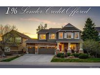 Inviting two-story home boasts stone accents, a two-car garage, and a beautifully landscaped front yard at 4307 Lilly Gulch Trl, Castle Rock, CO 80109