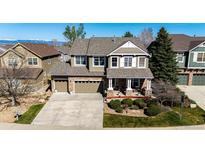 Beautiful two-story home featuring a stone facade, large driveway, and well-maintained landscaping at 4307 Lily Gulch Trl, Castle Rock, CO 80109