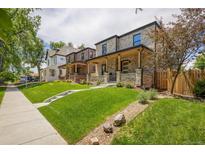 Street view of newly built brick home featuring a well-manicured lawn and covered front porch at 2521 N Gaylord St, Denver, CO 80205
