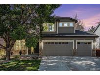 Charming two-story home showcasing a three-car garage and well-manicured lawn at 13087 Krameria St, Thornton, CO 80602