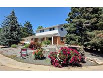 Charming two-story home with brick accents, colorful landscaping, and a well-maintained front yard at 984 S Braun Dr, Lakewood, CO 80228