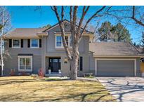 Charming two-story home with neutral gray siding and beautiful landscaping at 5666 S Havana Ct, Englewood, CO 80111