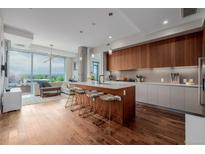 Bright kitchen featuring a large island with seating and modern wood cabinetry at 4200 W 17Th Ave # 625, Denver, CO 80204