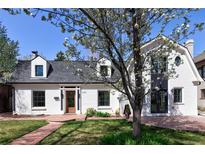 Charming home featuring a brick pathway leading to a beautifully maintained front yard at 2025 Ash St, Denver, CO 80207