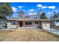 Charming single-story home featuring a well-maintained lawn, inviting entrance, and an attached one car garage at 3000 S Jackson St, Denver, CO 80210
