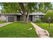Charming home with a well-manicured lawn and beautiful landscaping at 5436 E Atlantic Pl, Denver, CO 80222