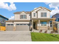 Charming two-story home featuring a three car garage and a welcoming front porch at 13486 Valentia St, Thornton, CO 80602