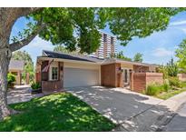 Charming single-story brick home with attached garage and mature trees in a residential neighborhood at 2552 E Alameda Ave # 92, Denver, CO 80209