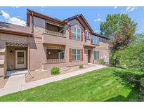 Charming two-story townhome with a well-maintained lawn and inviting facade at 11972 W Long Cir # 104, Littleton, CO 80127