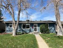 Charming single-story home with a well-maintained lawn and mature trees in a peaceful neighborhood at 4731 S Acoma St, Englewood, CO 80110