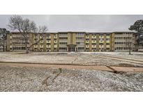 Multi-story condo building with well-maintained grounds on an overcast day at 655 S Alton Way # 6C, Denver, CO 80247