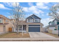 Charming two-story home with a well-maintained lawn and a two-car garage at 7362 E Villanova Pl, Denver, CO 80231