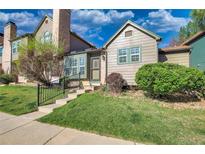 Charming multi-level home with a well-maintained front lawn and inviting entryway at 17325 E Rice Cir # F, Aurora, CO 80015
