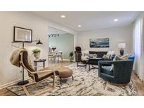 Bright living room boasts stylish furnishings and an open layout, creating an inviting and modern space at 3376 Jasmine St, Denver, CO 80207