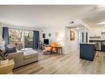 Inviting living room with a walkout balcony, light hardwood floors, and a neutral color palette at 5120 Williams Fork Trl # 214, Boulder, CO 80301