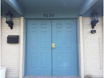 Image of the home's front double-doors with an address of 9450 and white-painted brickwork at 9240 E Girard Ave # 1, Denver, CO 80231